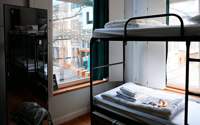A hostel room with bunk beds
