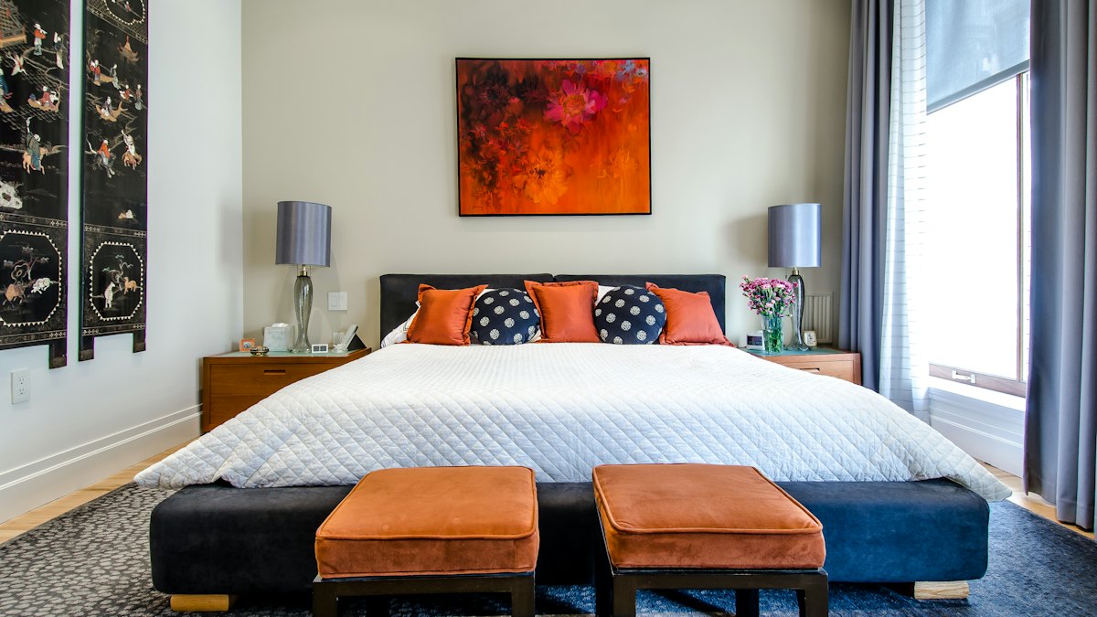 A bedroom with a neatly made bed