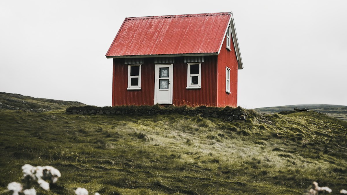 A small red house on a hill