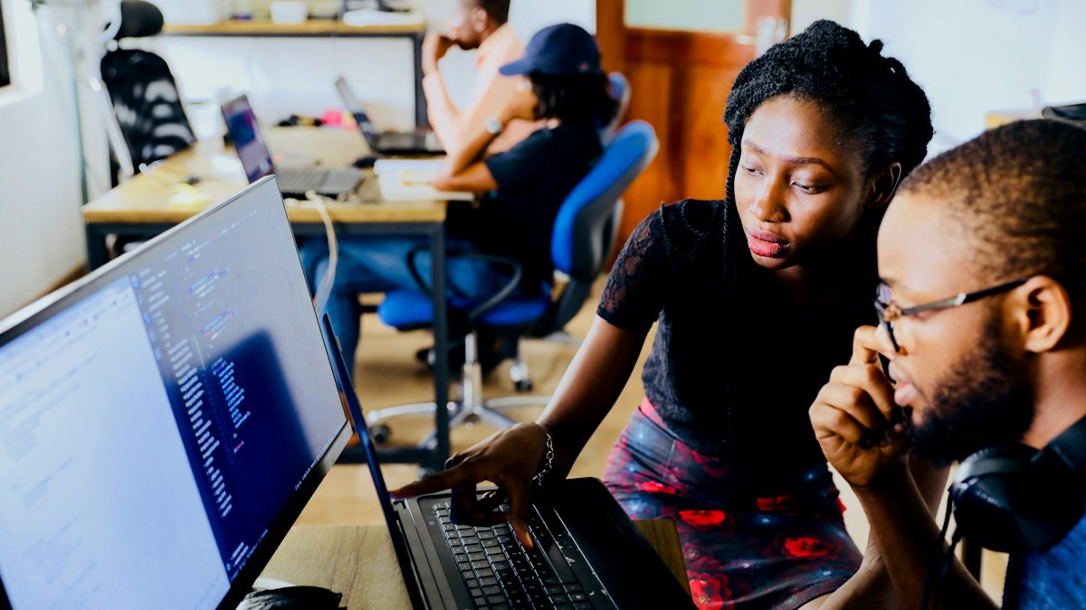 Two colleagues working together at a computer