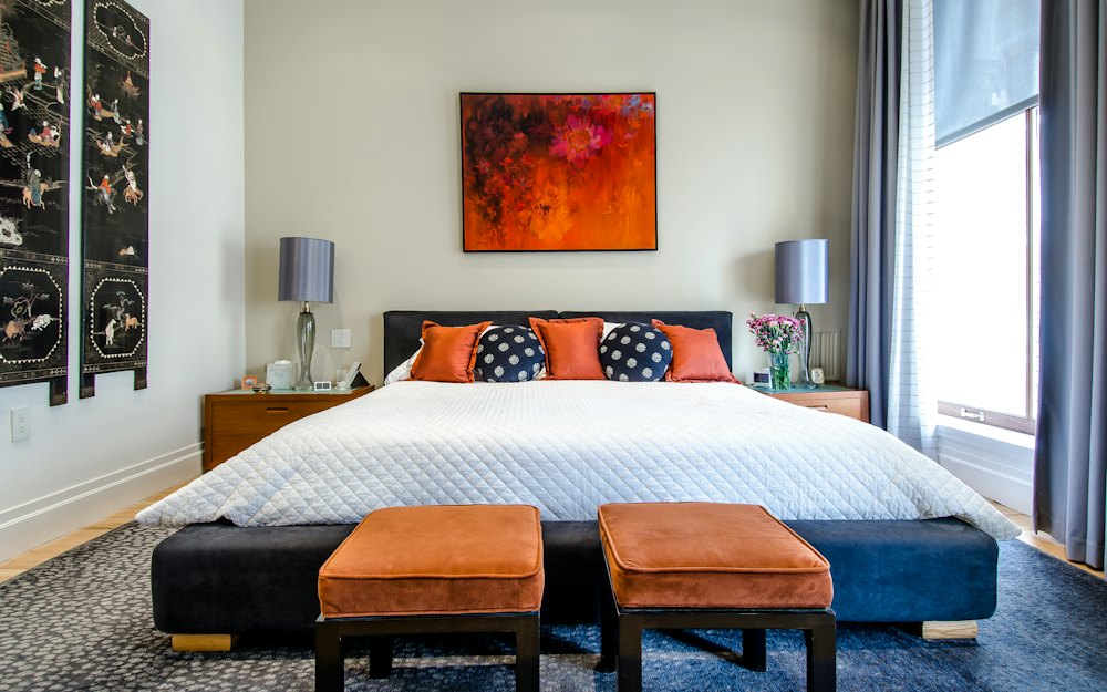 A bedroom with a neatly made bed