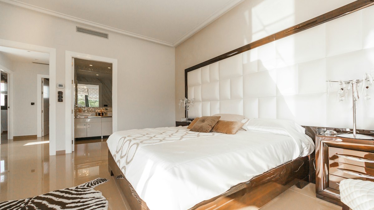 A bedroom with a white bed